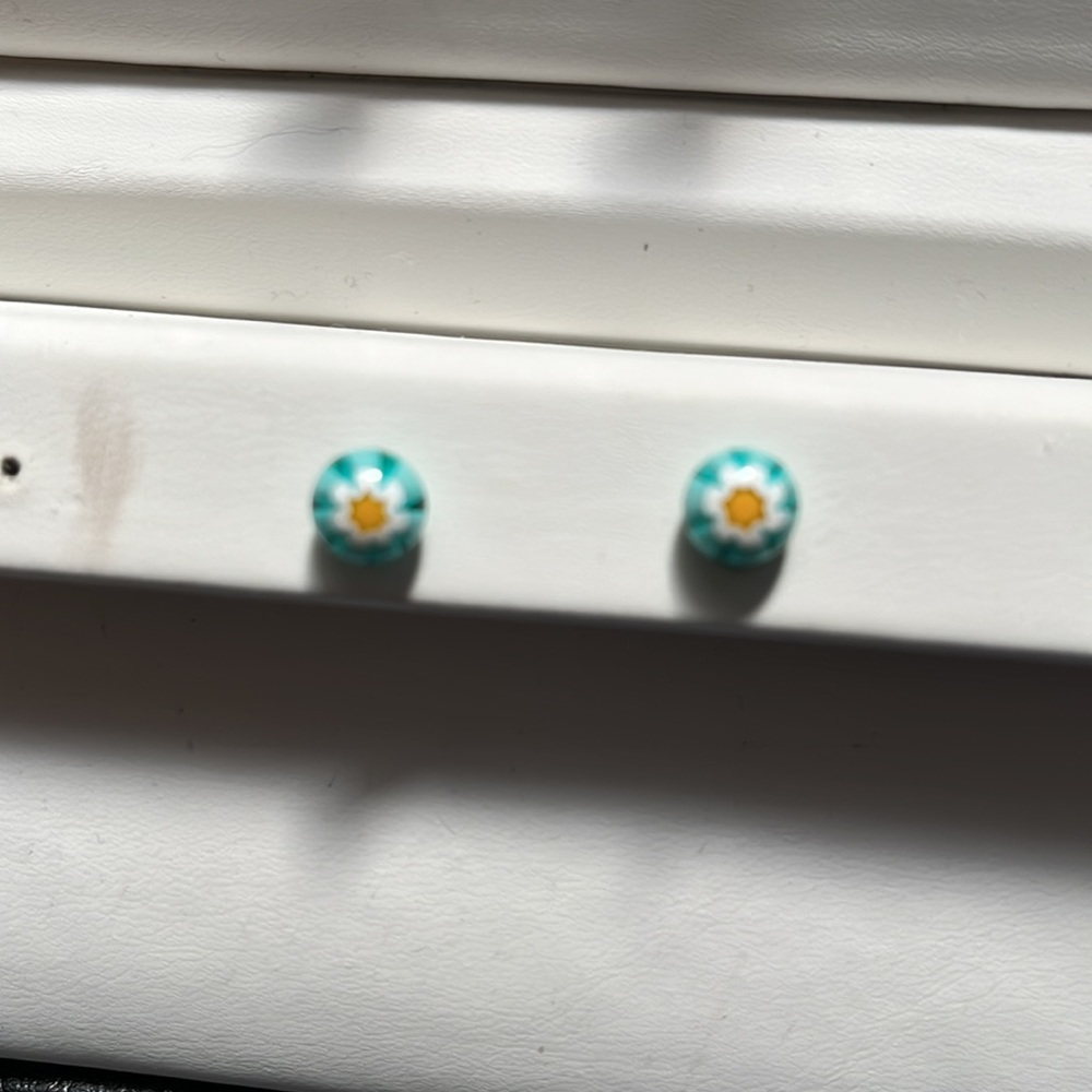 Turquoise colored Venetian glass with white flowers with yellow center